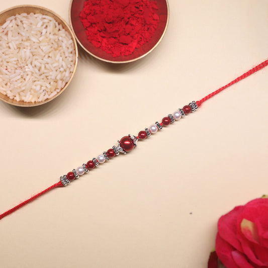 Shubh Laal Rakhi Pair – Celebrating Timeless Tradition in Crimson Glory & Sacred Affection (Set of 2)