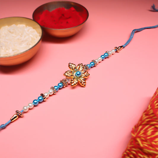 Ocean Bloom Rakhi Duo – Floral Gold & Crystal Blue Elegance