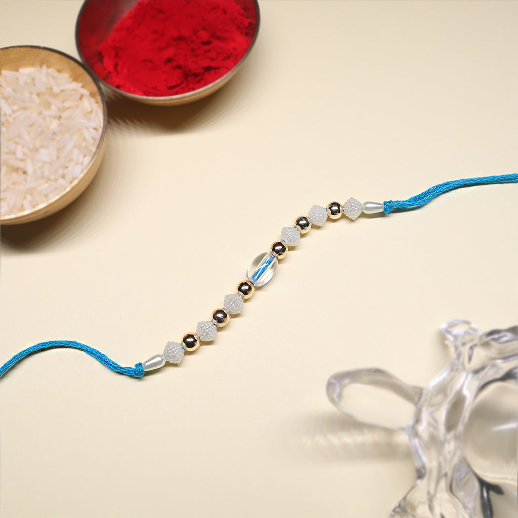 Ocean Bloom Rakhi Duo – Floral Gold & Crystal Blue Elegance