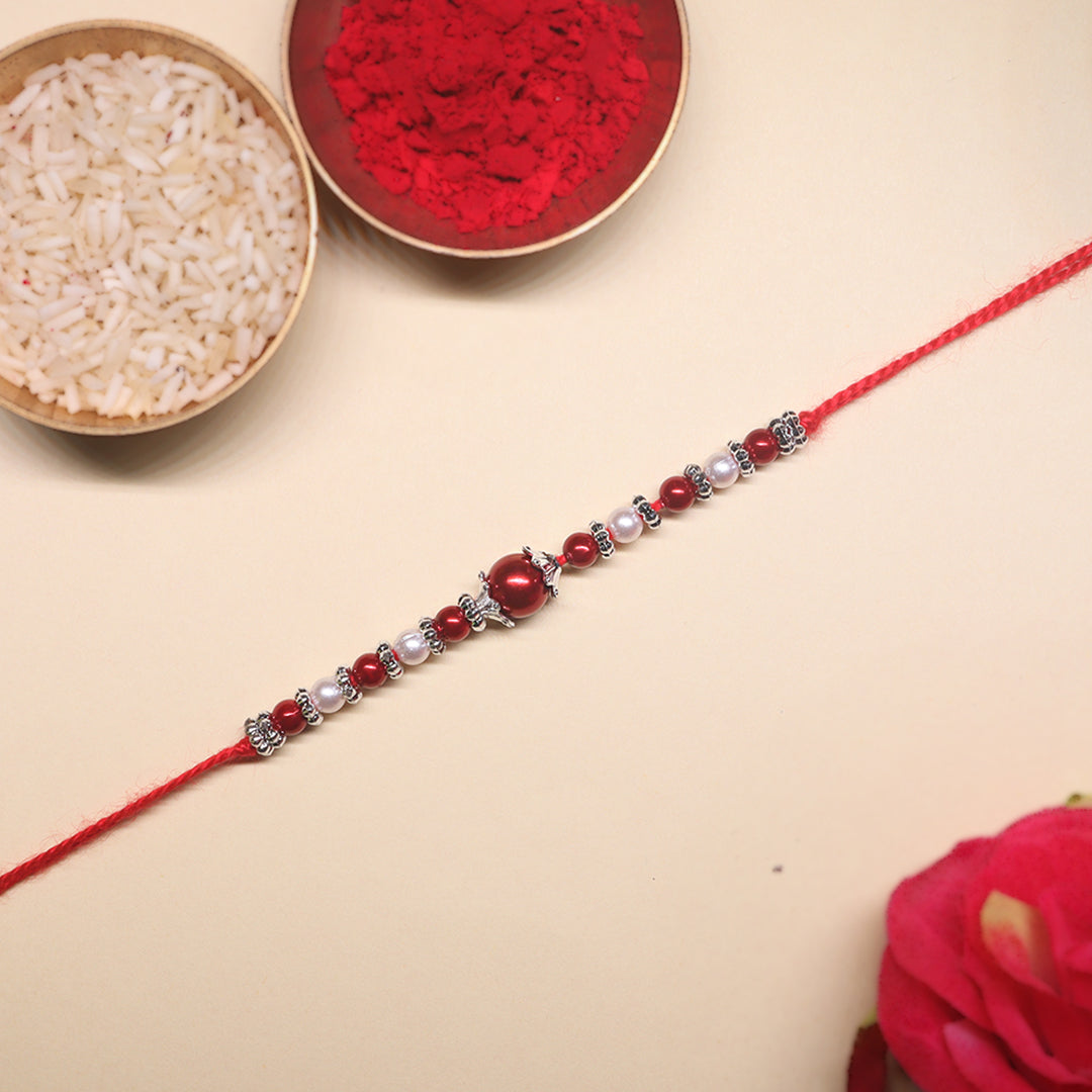 Shubh Laal Rakhi Pair – Celebrating Timeless Tradition in Crimson Glory & Sacred Affection (Set of 2)
