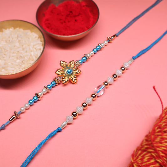 Ocean Bloom Rakhi Duo – Floral Gold & Crystal Blue Elegance