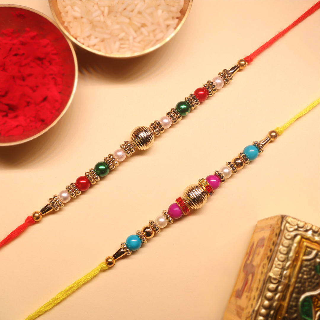 Golden Harmony Rakhi Set – A Duo of Tradition, Color & Festive Elegance