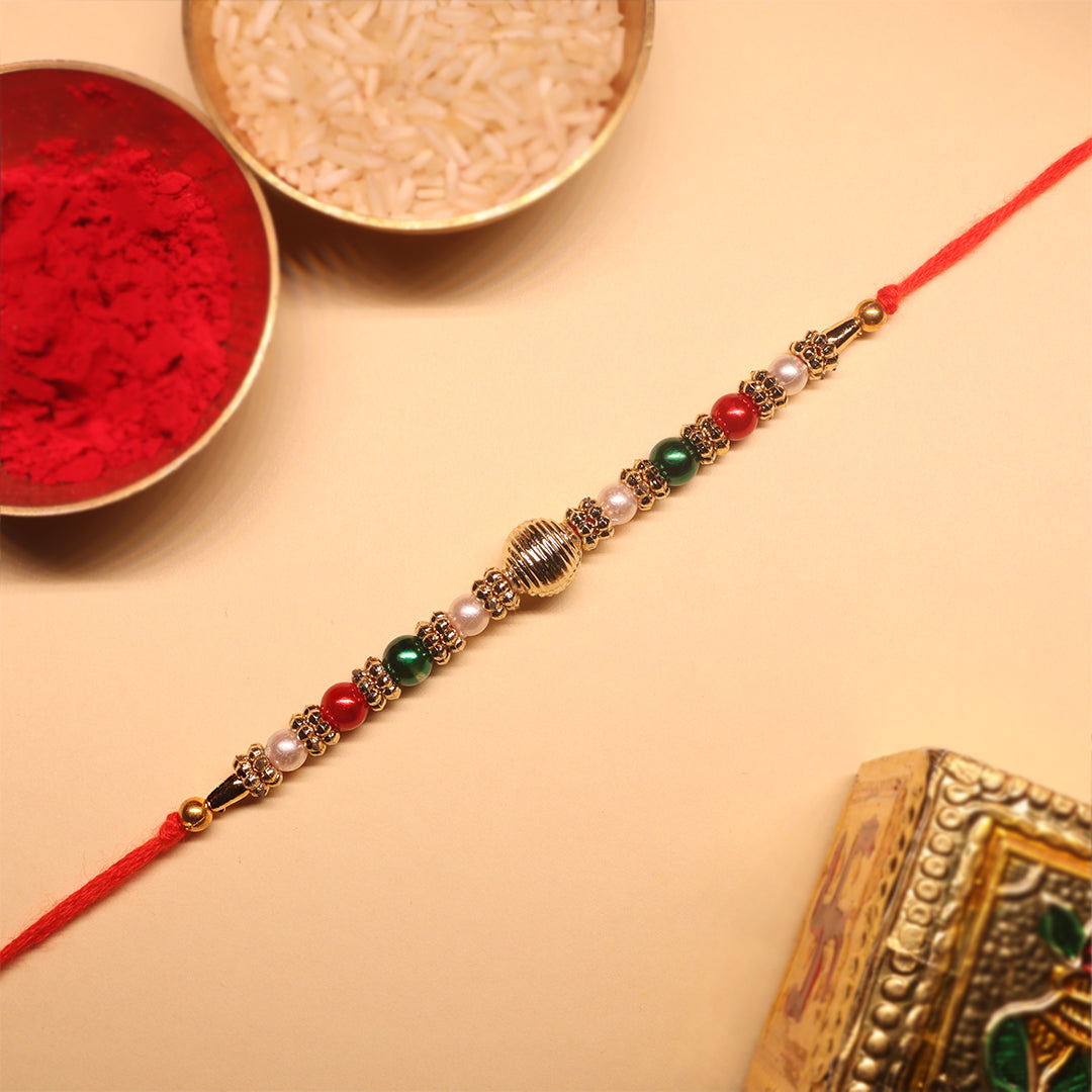 Golden Harmony Rakhi Set – A Duo of Tradition, Color & Festive Elegance