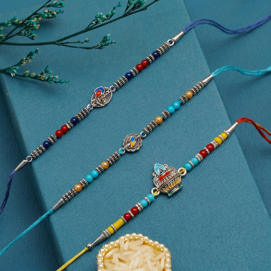 Enamel Heritage Rakhi Set – Crown, Mandala & Peacock-Inspired Charms ( Set of 3)